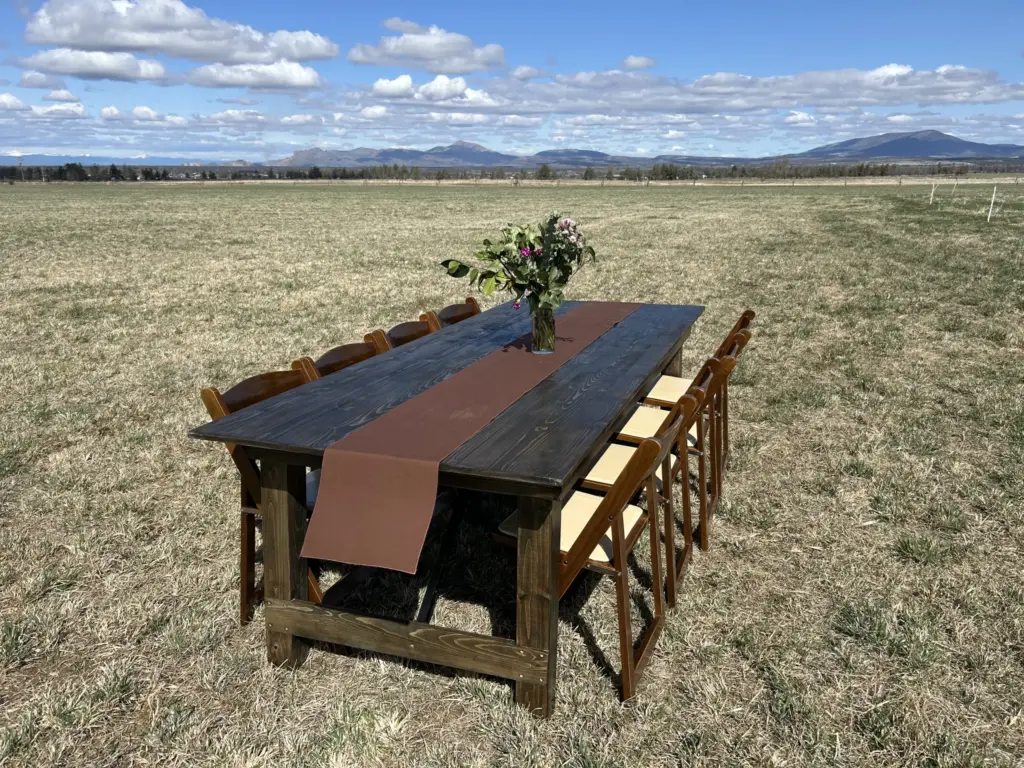 Farm Table Rentals in a field with greenery